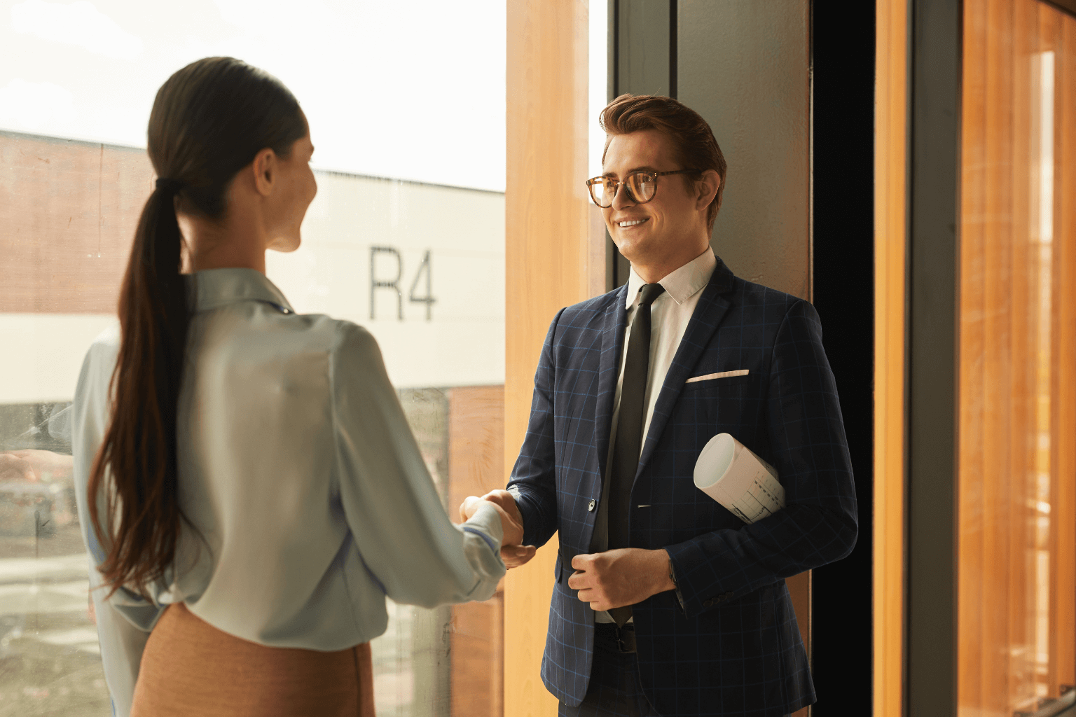 Real estate agent shaking hands with home buyer