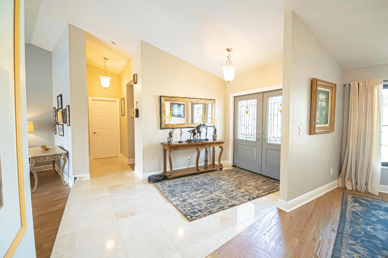 Foyer transformation in Concord, CA home with fresh paint, vibrant rug, and vintage décor