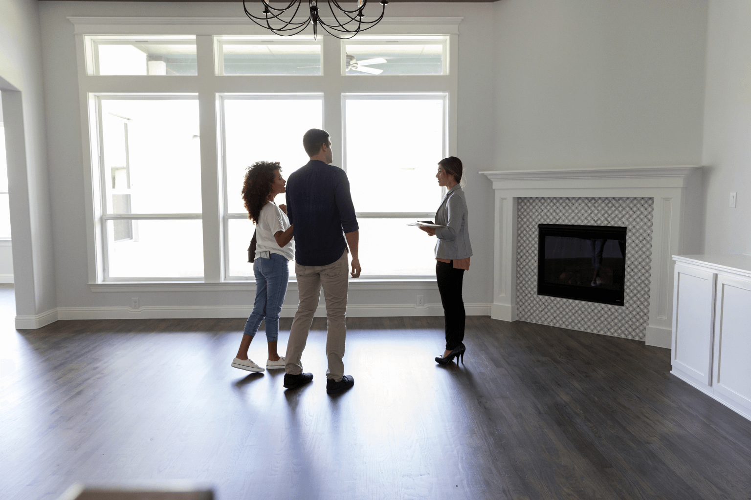Real estate agent showing a home to potential buyers.