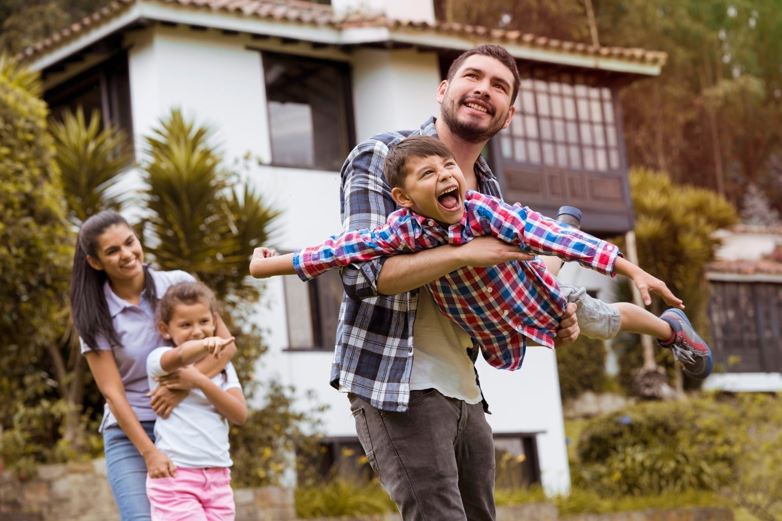 Happy homebuyers standing in front of their new home in Orinda California