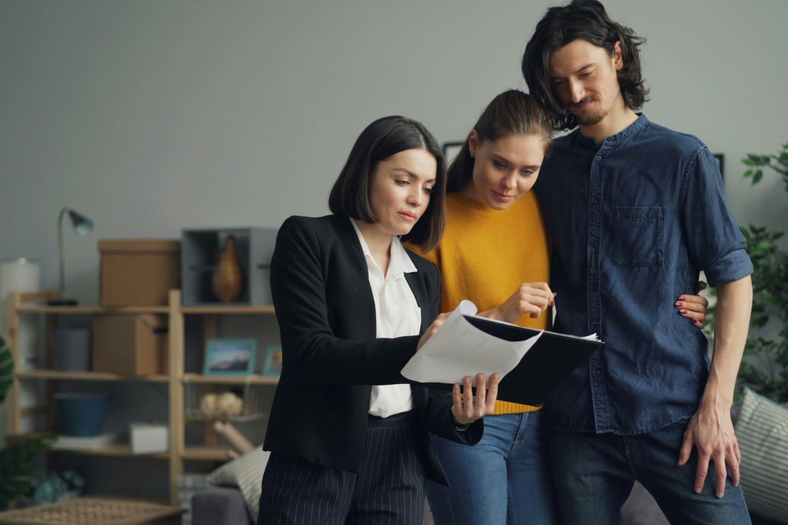 Real estate agent showing marketing plan and home listing to clients in Orinda