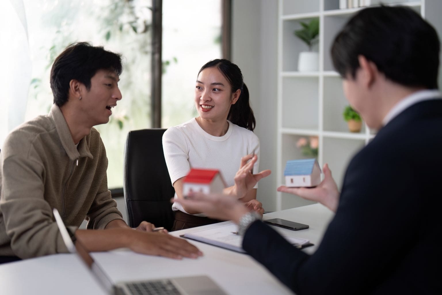 Real estate agent and homeowners discussing home selling strategy