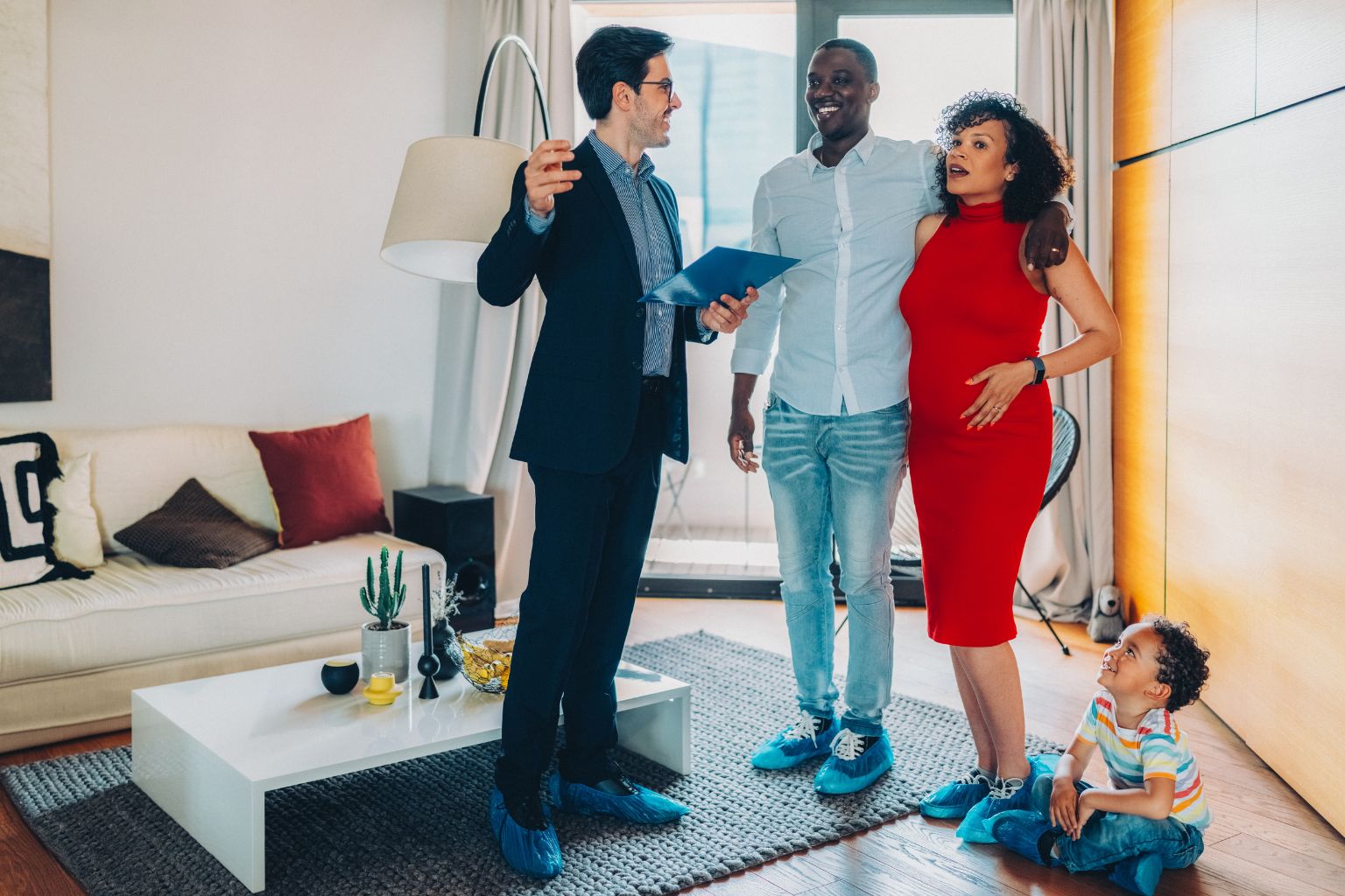 Real estate agent showing buyers a staged home