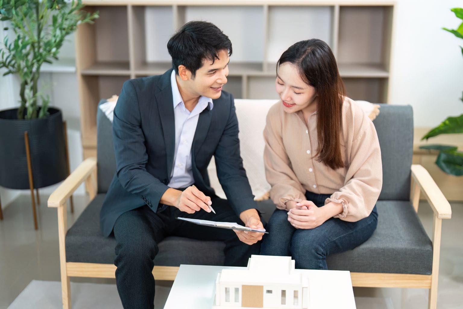 Real estate agent discussing home sale strategy with a client