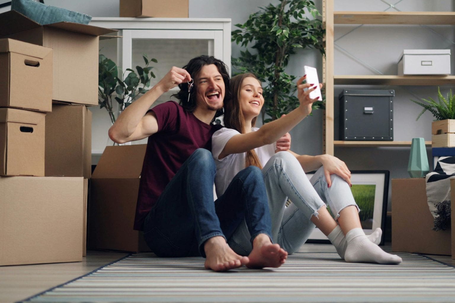Happy couple holding keys after selling their home