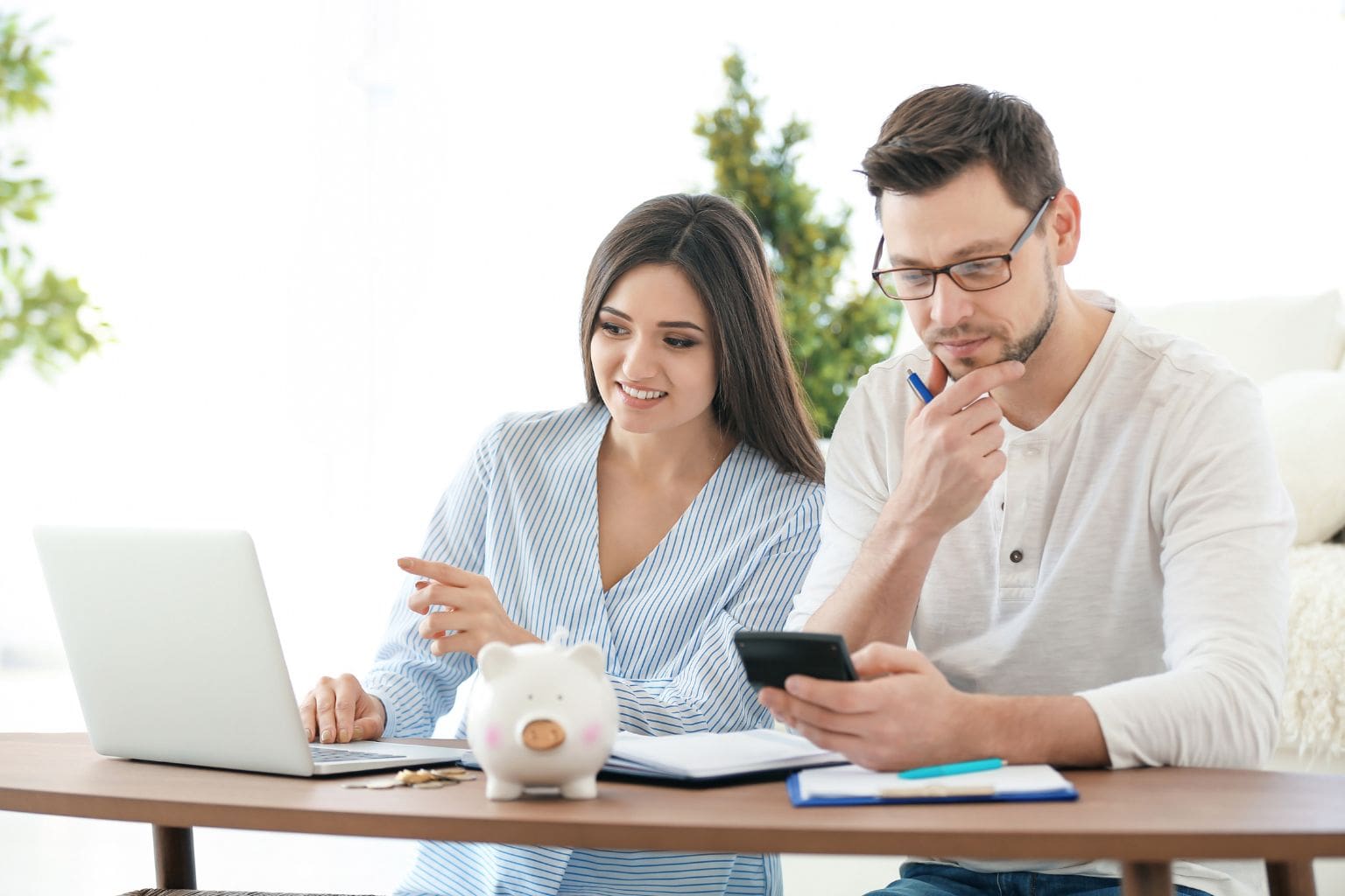 Creative Financing Tips for Buyers in Concord: Young couple reviewing home financing options at a table with a laptop