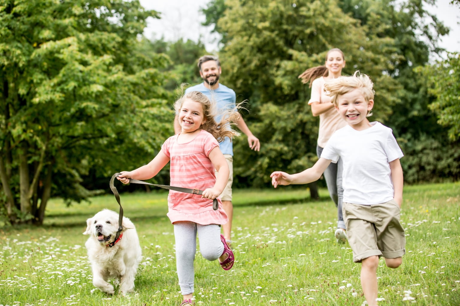 a happy family playing in a park