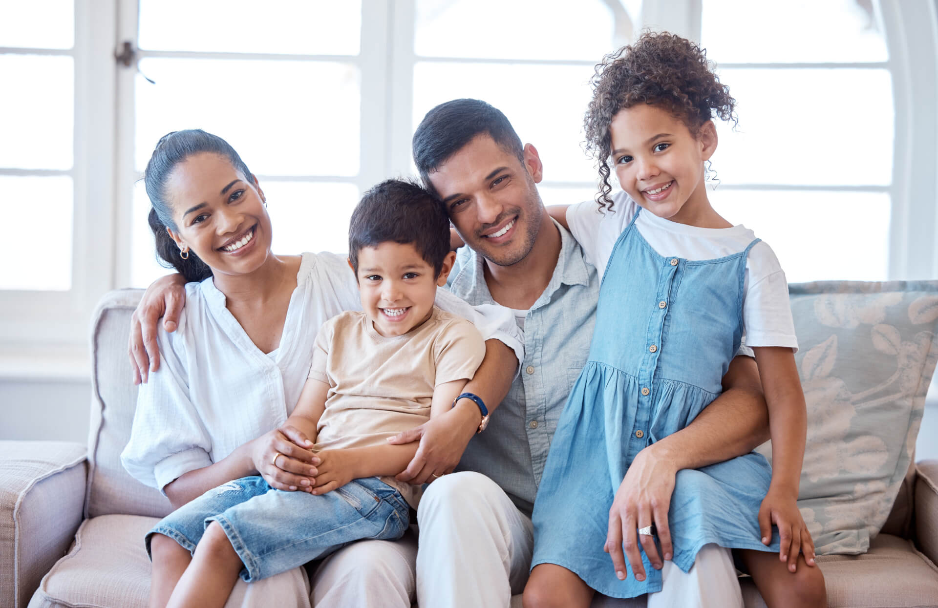 Young family, children and happy on living room couch