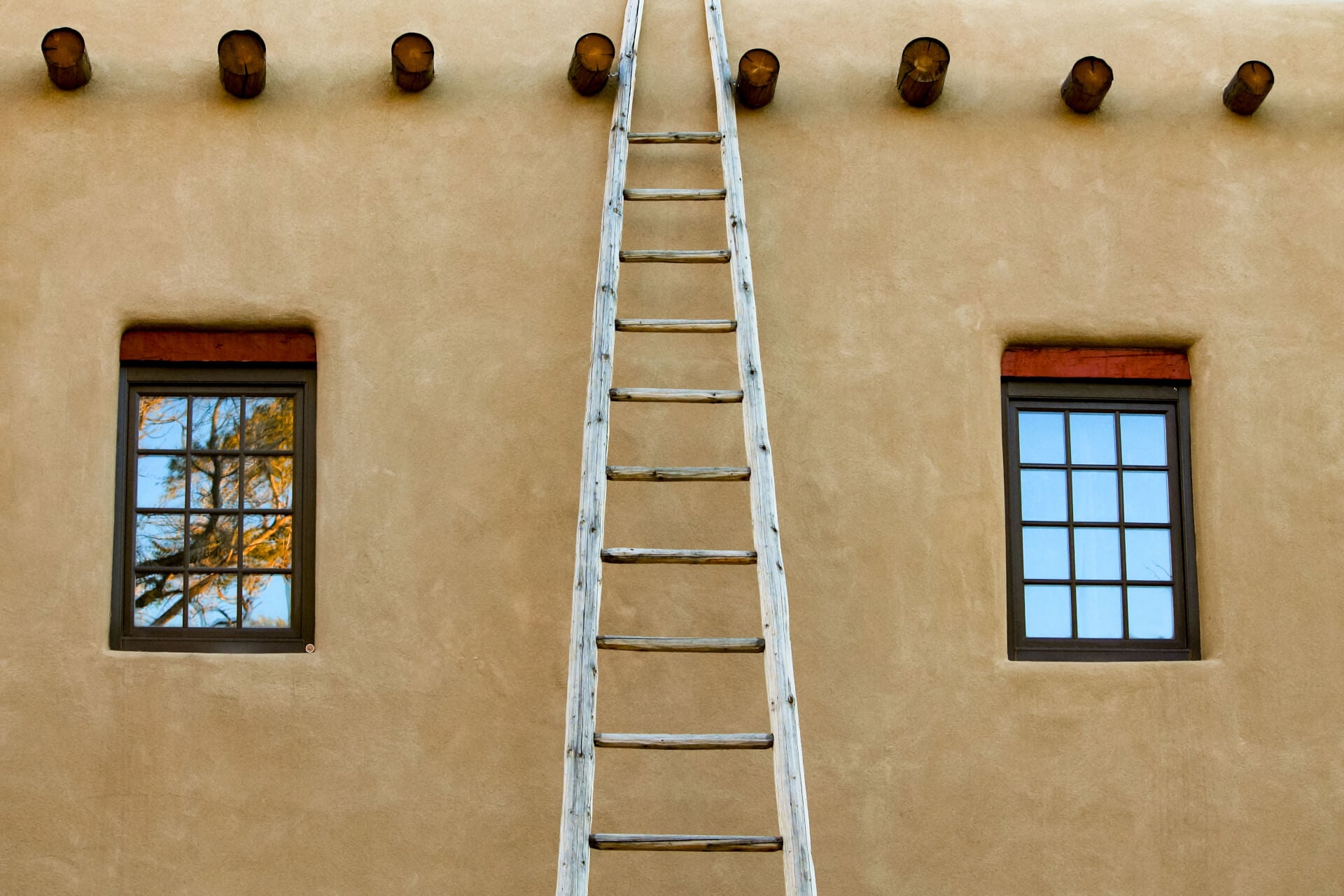 A ladder on a facade of a building in Taos , New Mexico