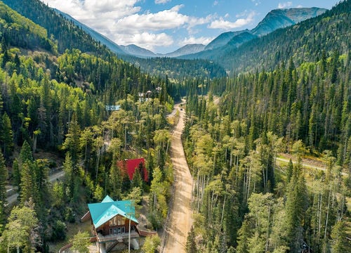 Taos Ski Valley, NM real estate with mountain homes, alpine forest, and canyon views in the Sangre de Cristo Mountains.