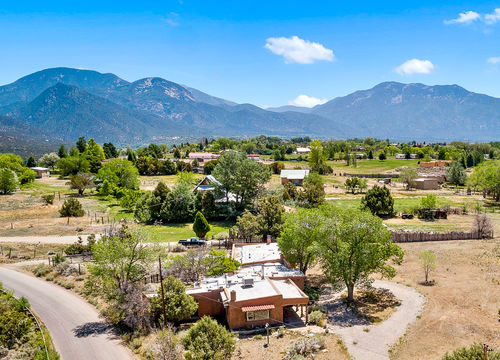Valdez, NM adobe home with mountain and valley views in the Sangre de Cristo Mountains, showcasing Taos County real estate.
