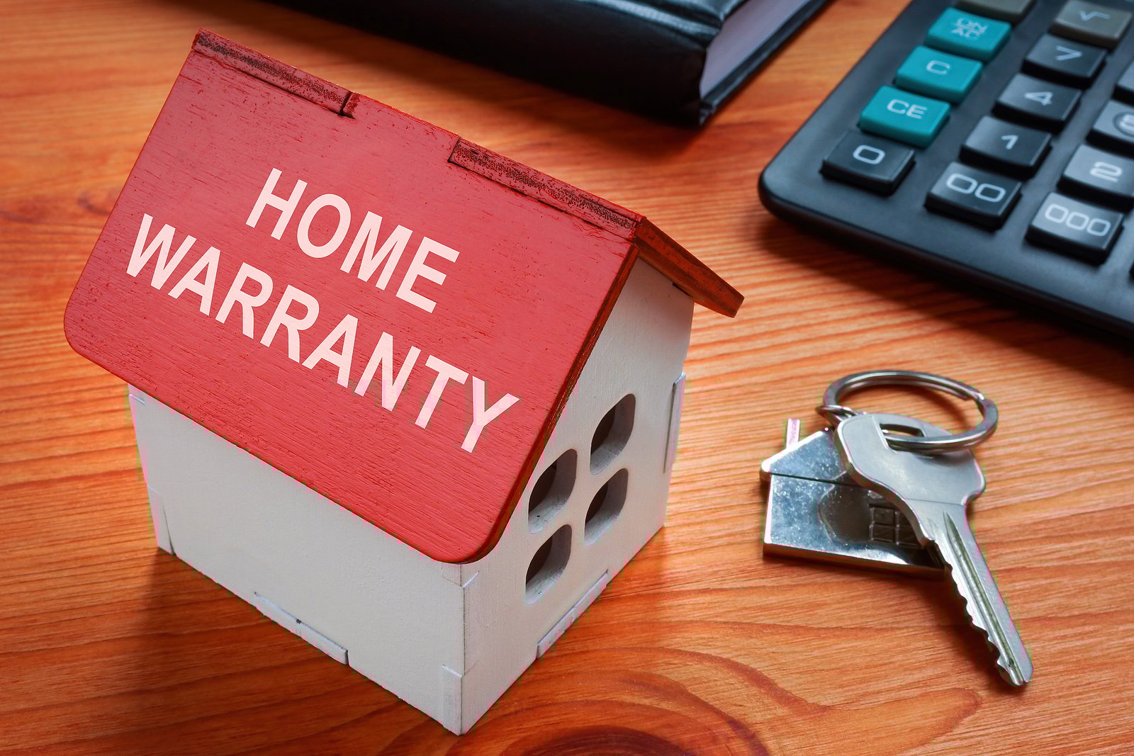 Model Of House With Inscription Home Warranty.
