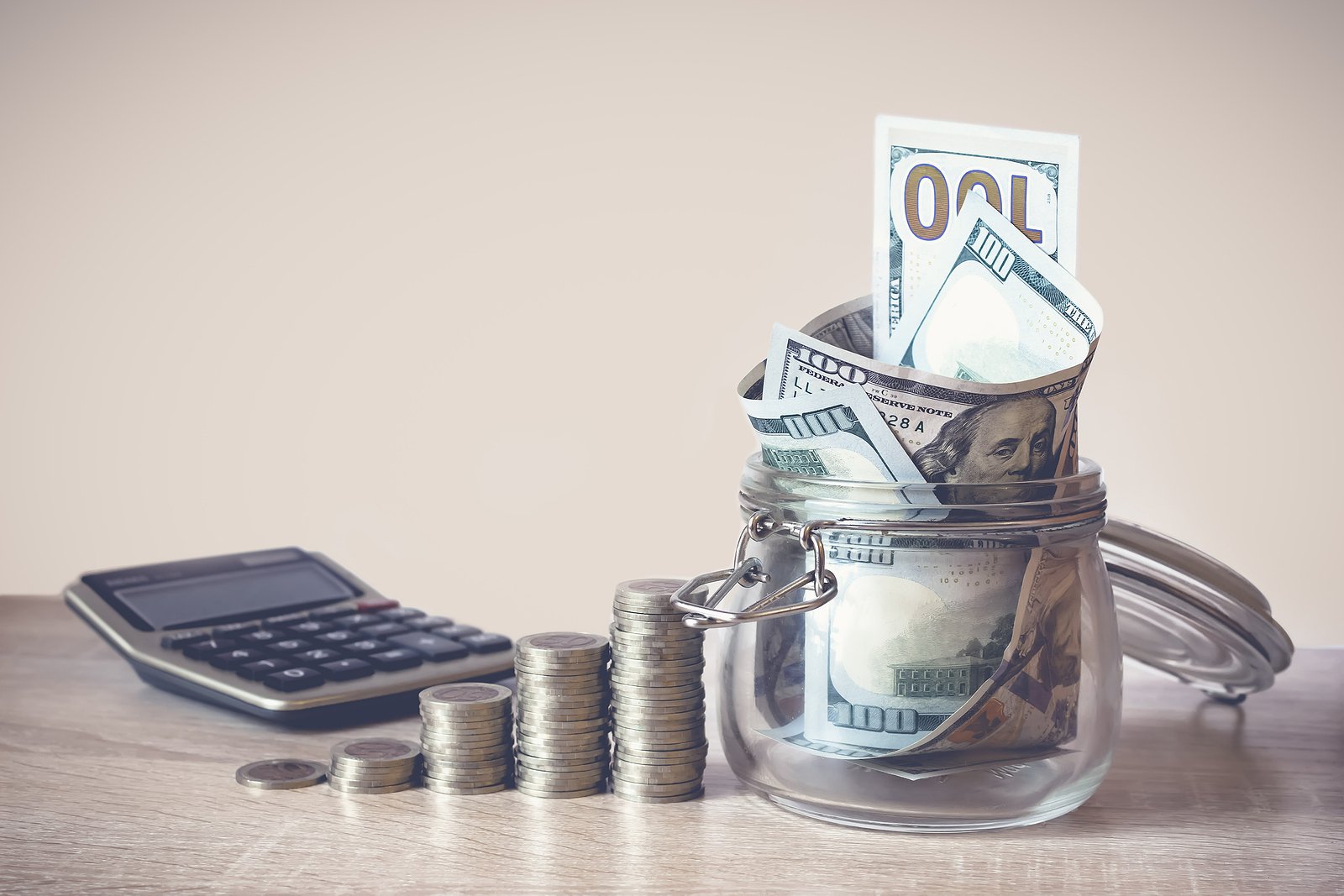 Coins Stack, Calculator And Us Dollar Bills In The Glass Jar. Co