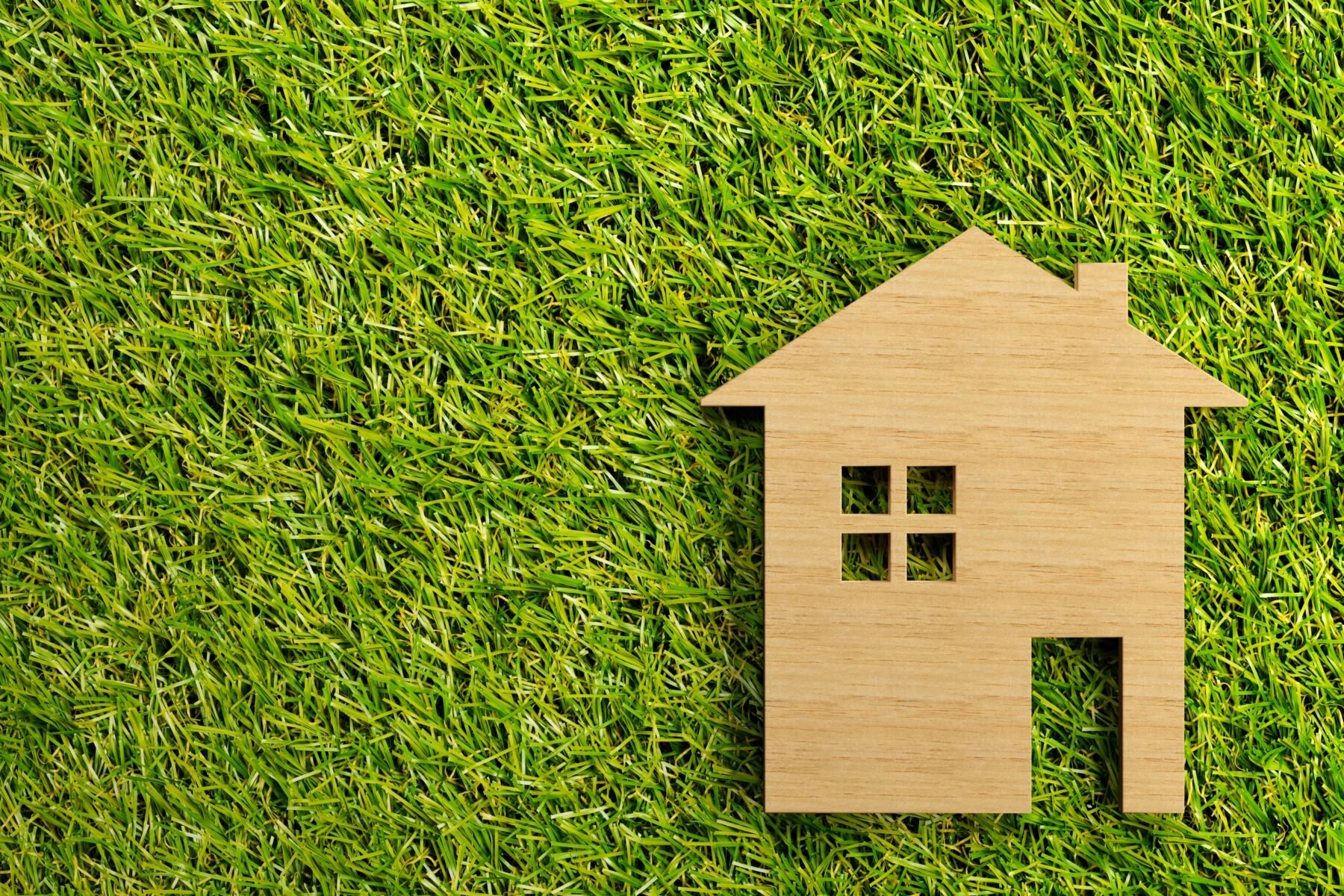 Little Wooden Miniature House Model On Green Grass Background Wi