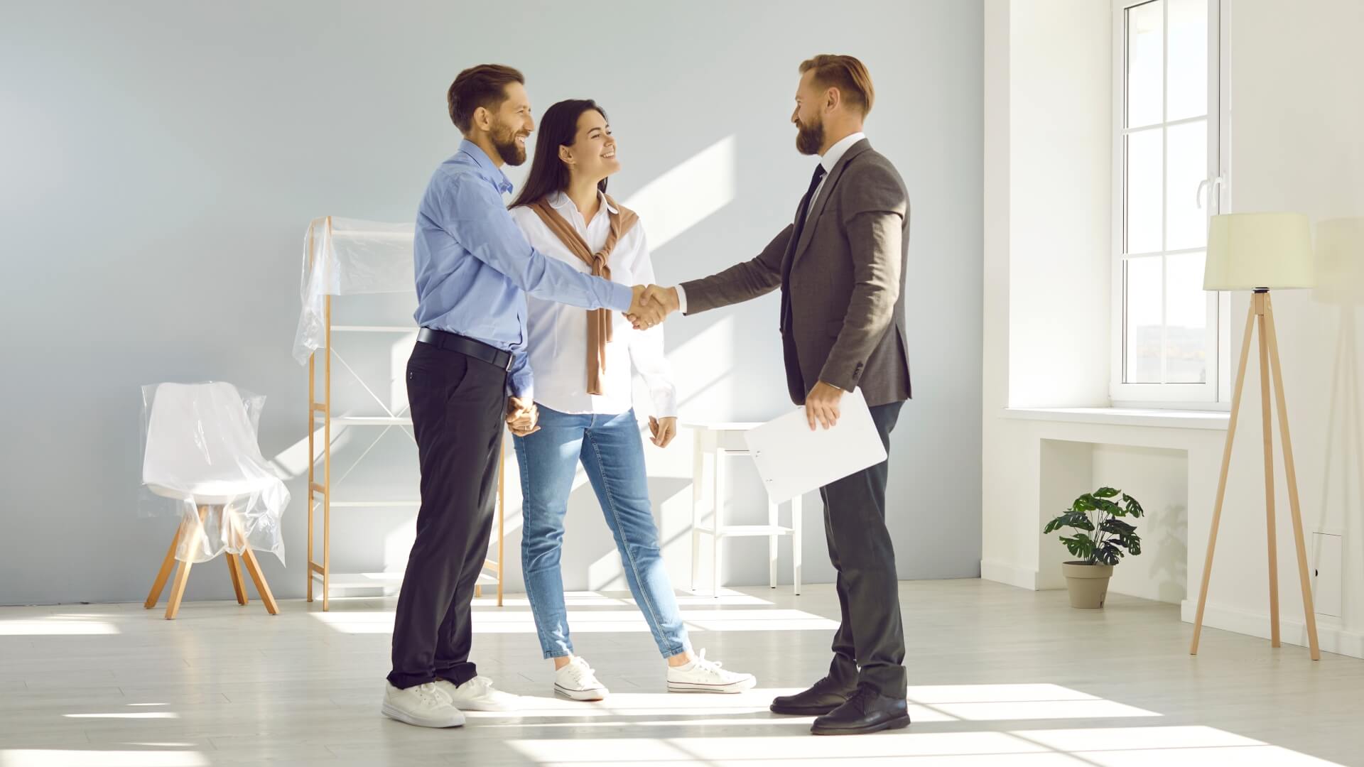 Young married couple make deal, buy new house