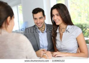 stock-photo-young-couple-signing-financial-contract-119960122