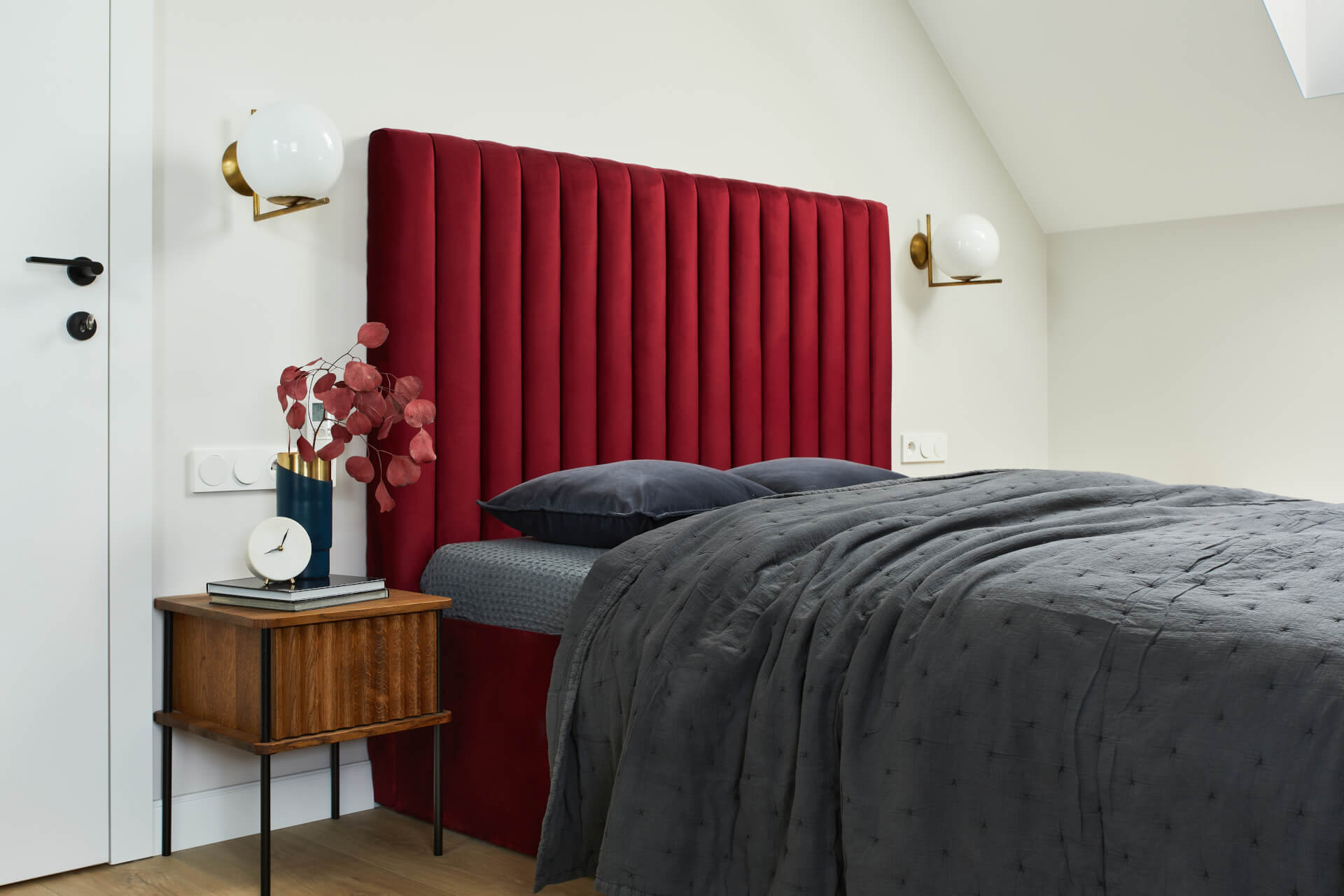elegant bedroom interior with red bed, grey bedclothes