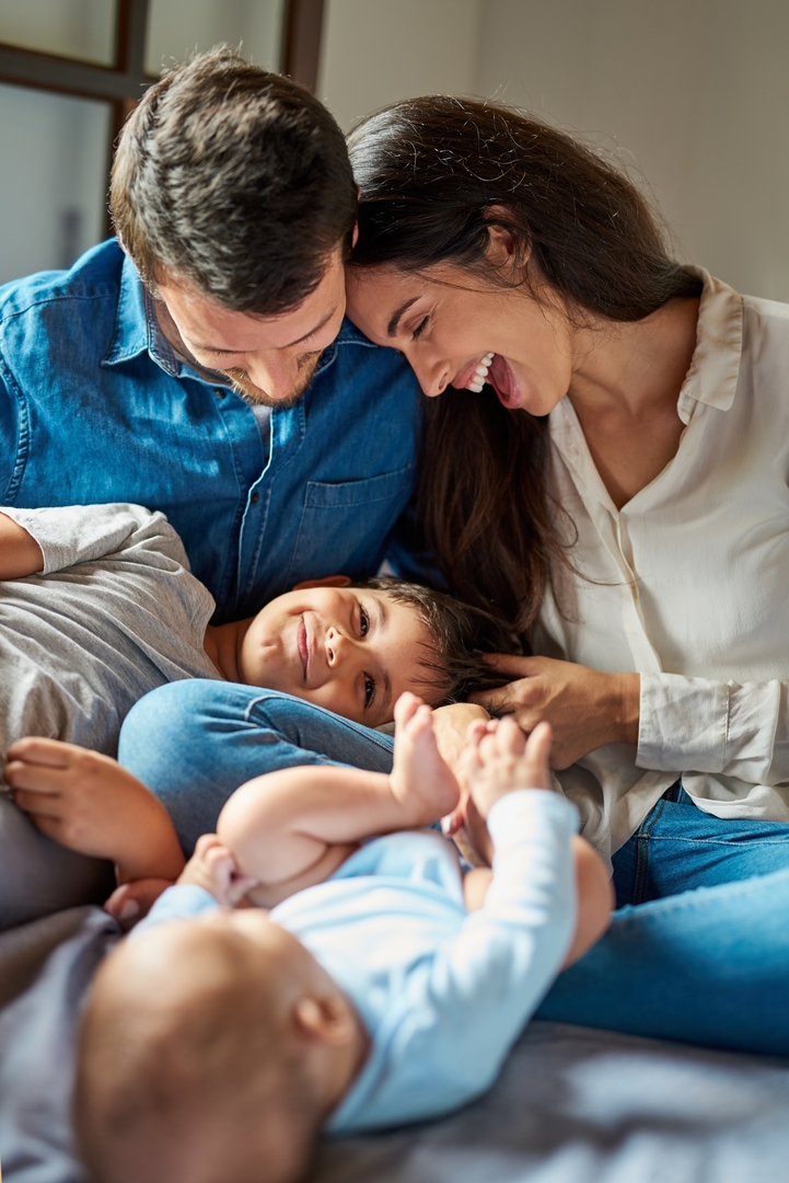 Funny,,Love,And,Tickle,With,Family,On,Bed,In,Home