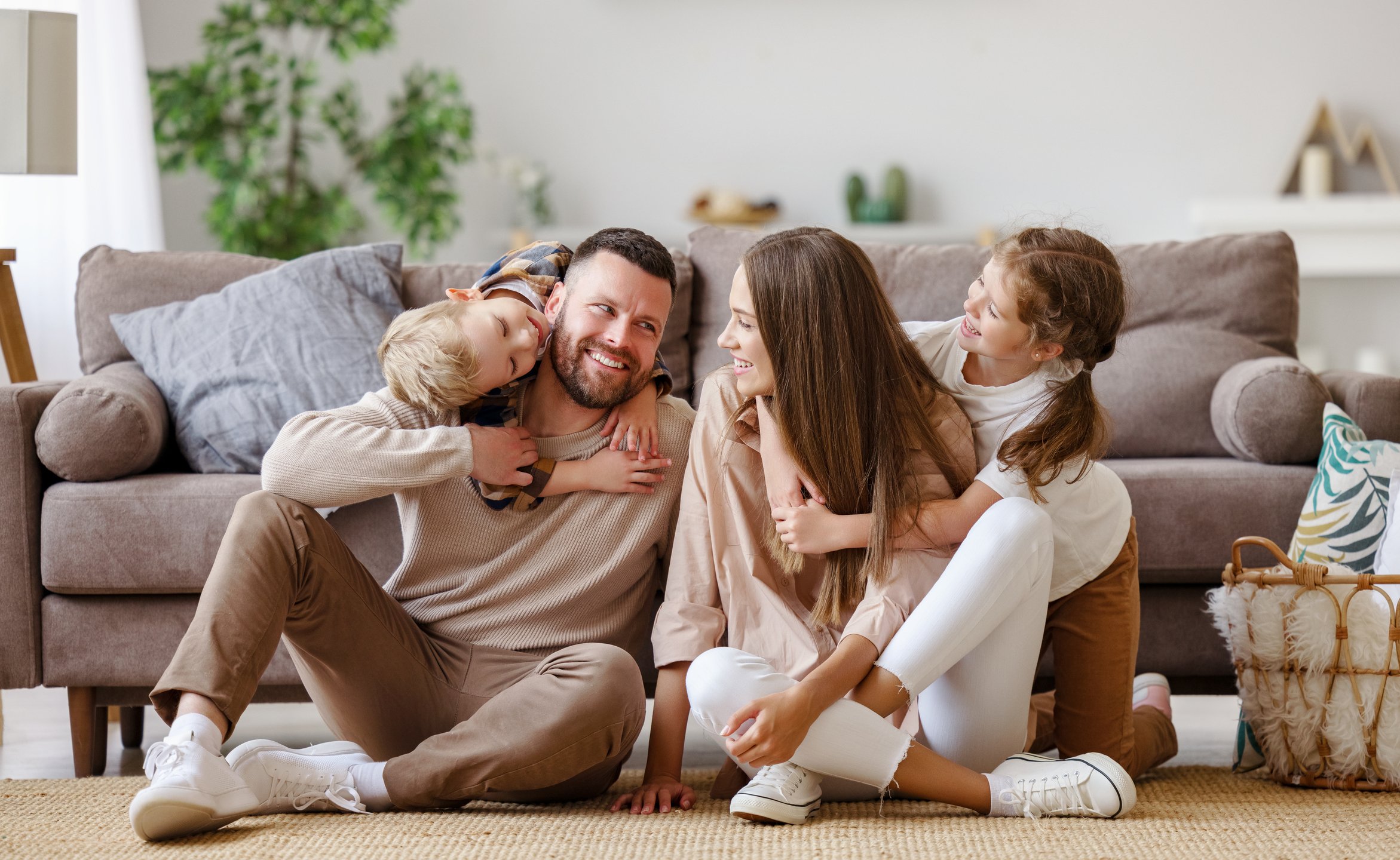 Happy,Family,Mother,Father,And,Children,At,Home,On,Floor