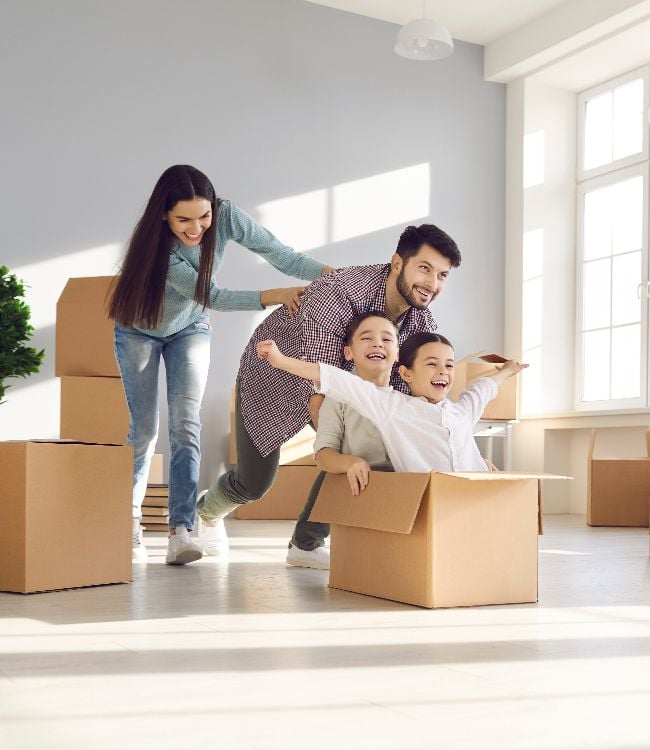 Joyful family with kids having fun in new home(1) - Copy