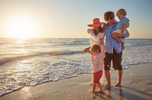 Family,,Parents,And,Children,On,Beach,Trip,For,Holiday,Fun,