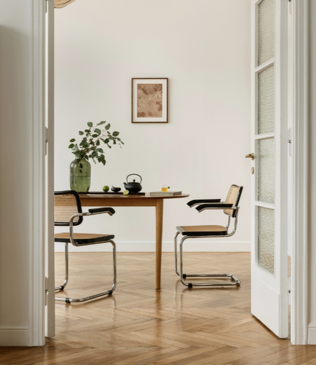 Minimalist dining room, modern chairs, wooden table, green vase with yellow flowers.(2)