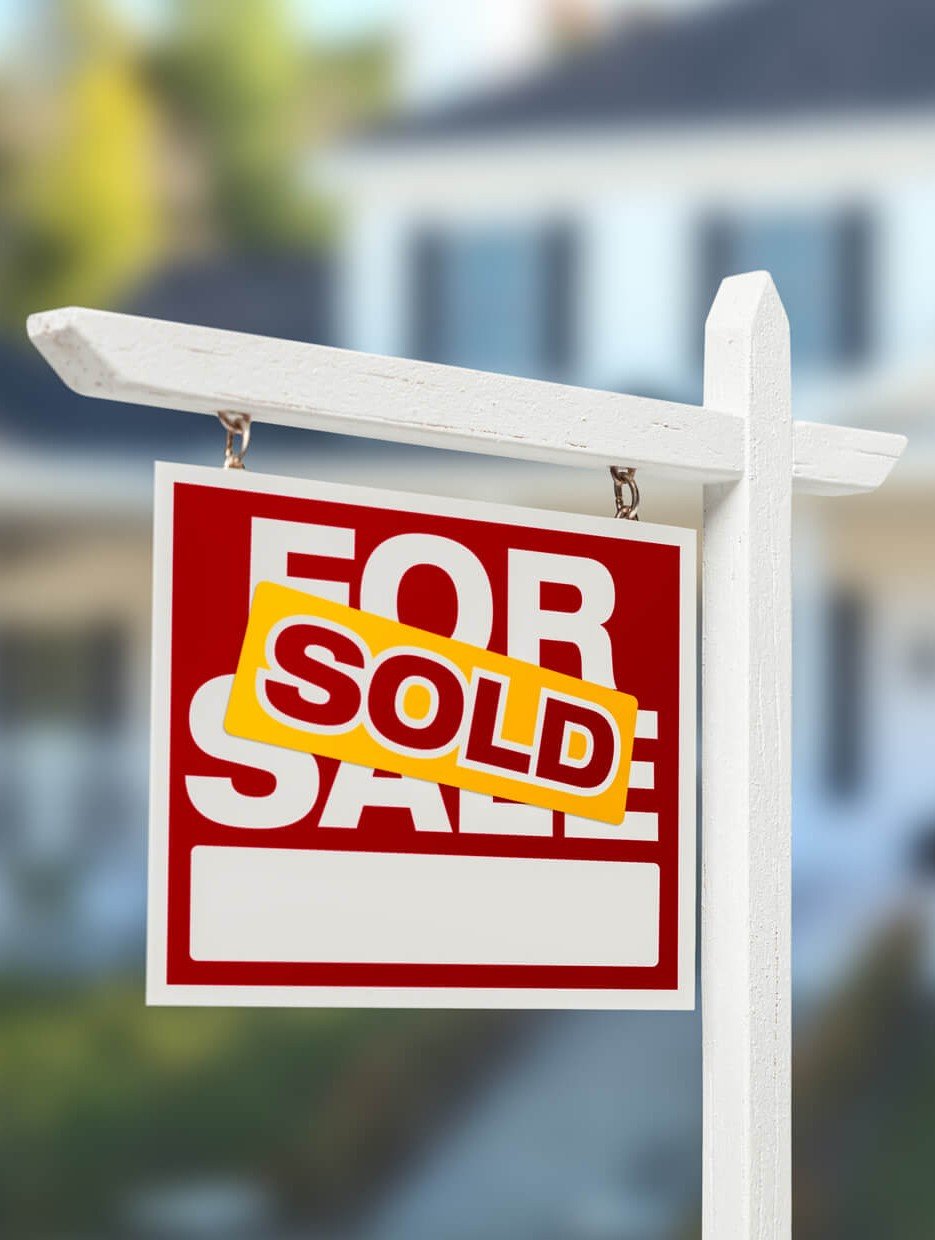 Sold Home For Sale Real Estate Sign in Front of Beautiful New House.