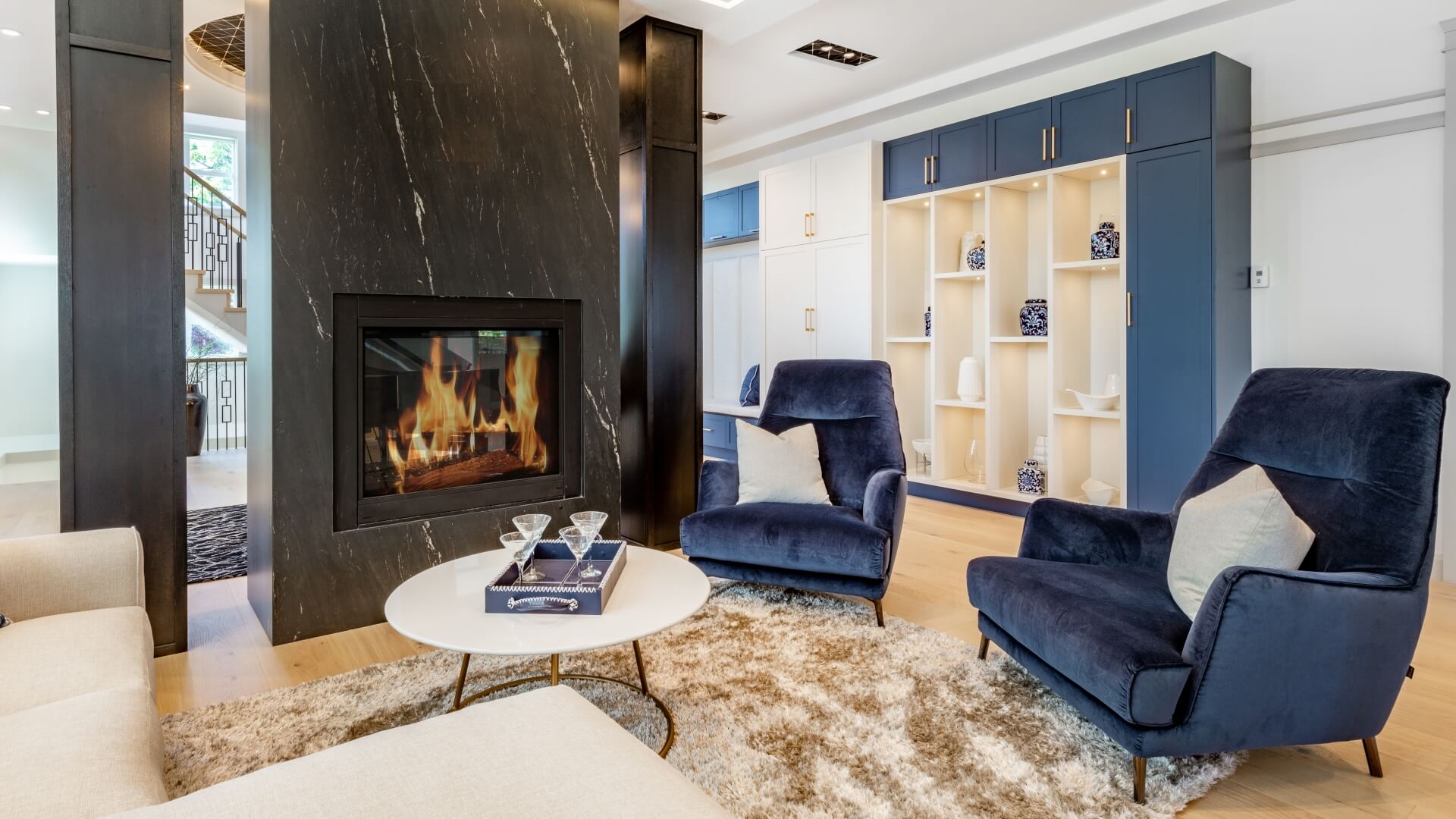 Casual seating around a fireplace interior with colorful arm chair blue