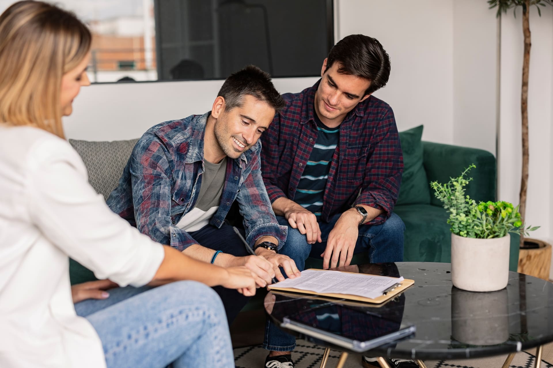 gay couple in real estate signing the purchase of their new house