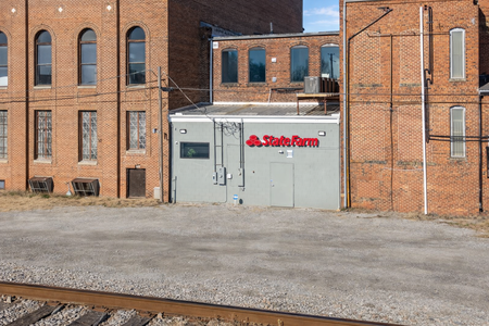 State Farm office near railroad tracks
