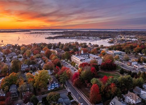 Fall sunset over Port Washington on the Long Island sound with red foliage, Manhasset, Nassau County