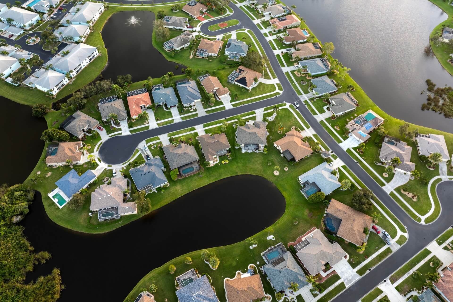 American gated community houses in rural US suburbs. View from above of large residential homes in small town in southwest Florida