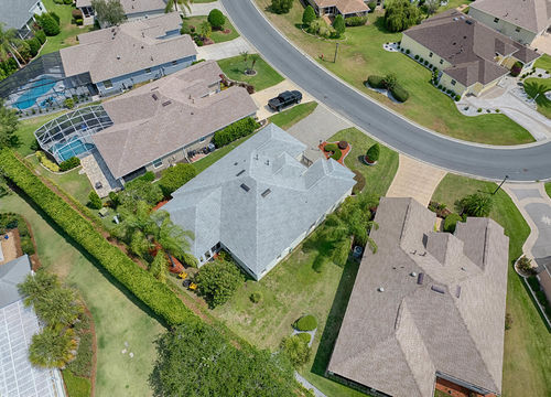 Aerial view of a master-planned residential community with curved streets, single-story homes