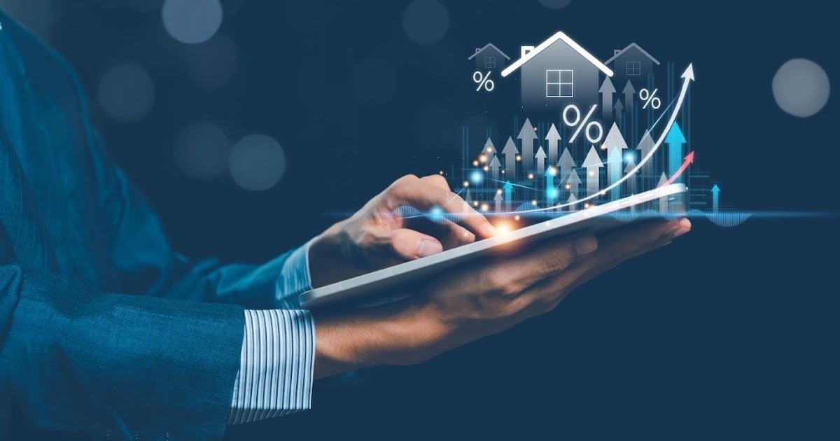 Businessman holding virtual graph showing real estate market growth