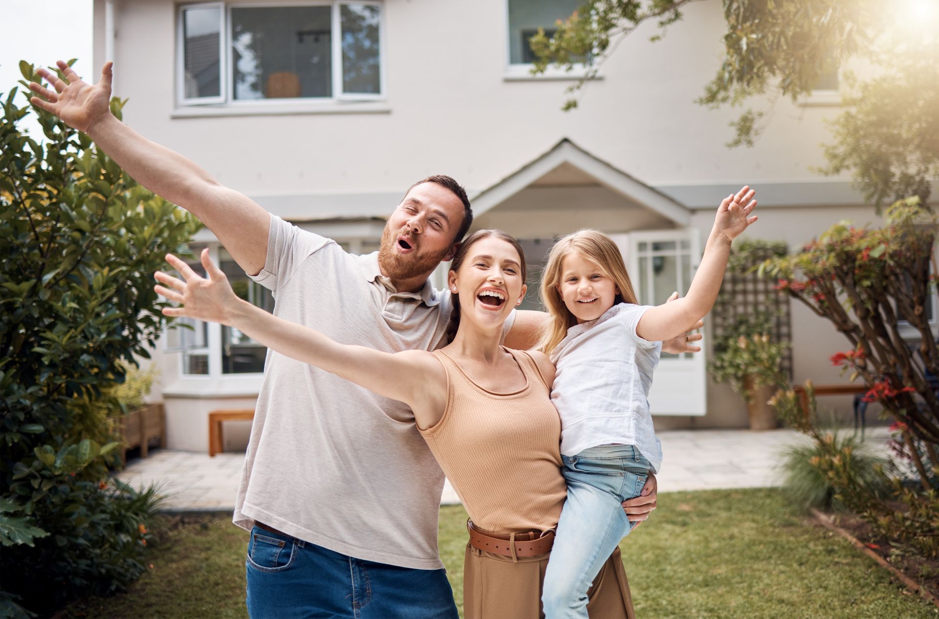 New building residential house purchase apartment concept. Stylish full family with two kids sitting on carpet, mom and dad making roof figure with hands arms over heads 1