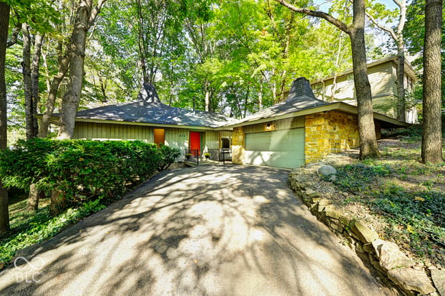 The Woods House at 252 W Beverly Dr, Indianapolis, a 1967 midcentury modern by architect Clyde E. Woods set into a wooded ravine