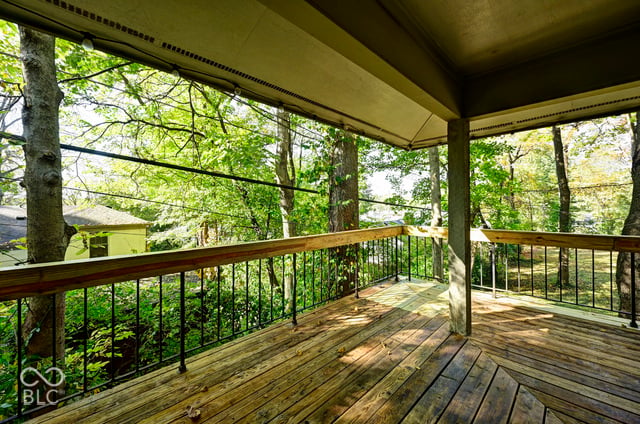 Covered dining room balcony in the treetops at the Woods House