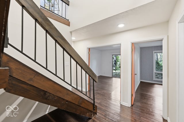 Double-height stairwell with an open floating staircase in the Woods House