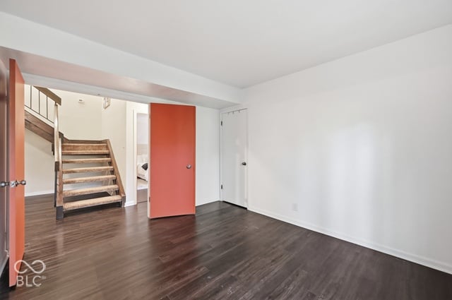 Lower-level bedroom behind double doors with a sliding glass door to the yard