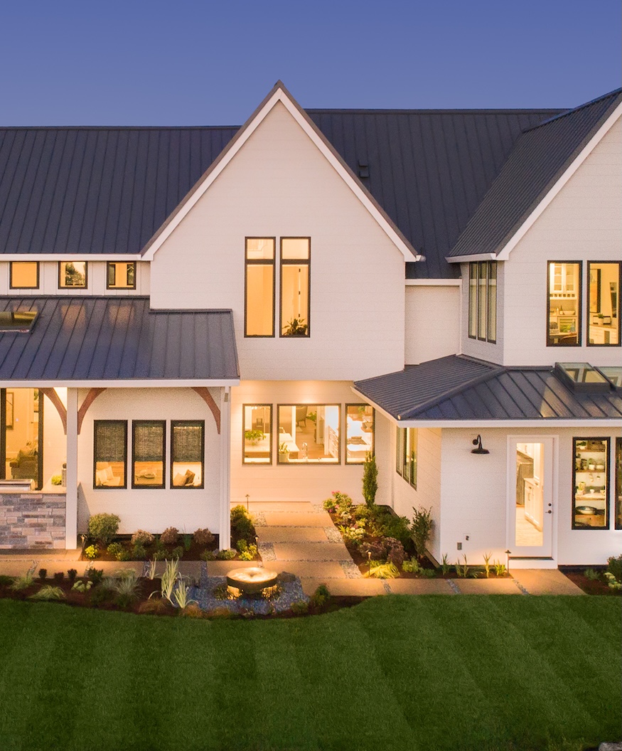 Luxury Home Exterior at Night Beautiful New House with Large Yard, Outdoor Covered Patio with Kitchen, and Glowing Interior Lights (1)