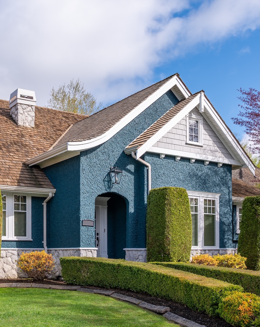 Two story stucco luxury house with nice spring blossom landscape in Vancouver, Canada, North America. Day time on April 2025.