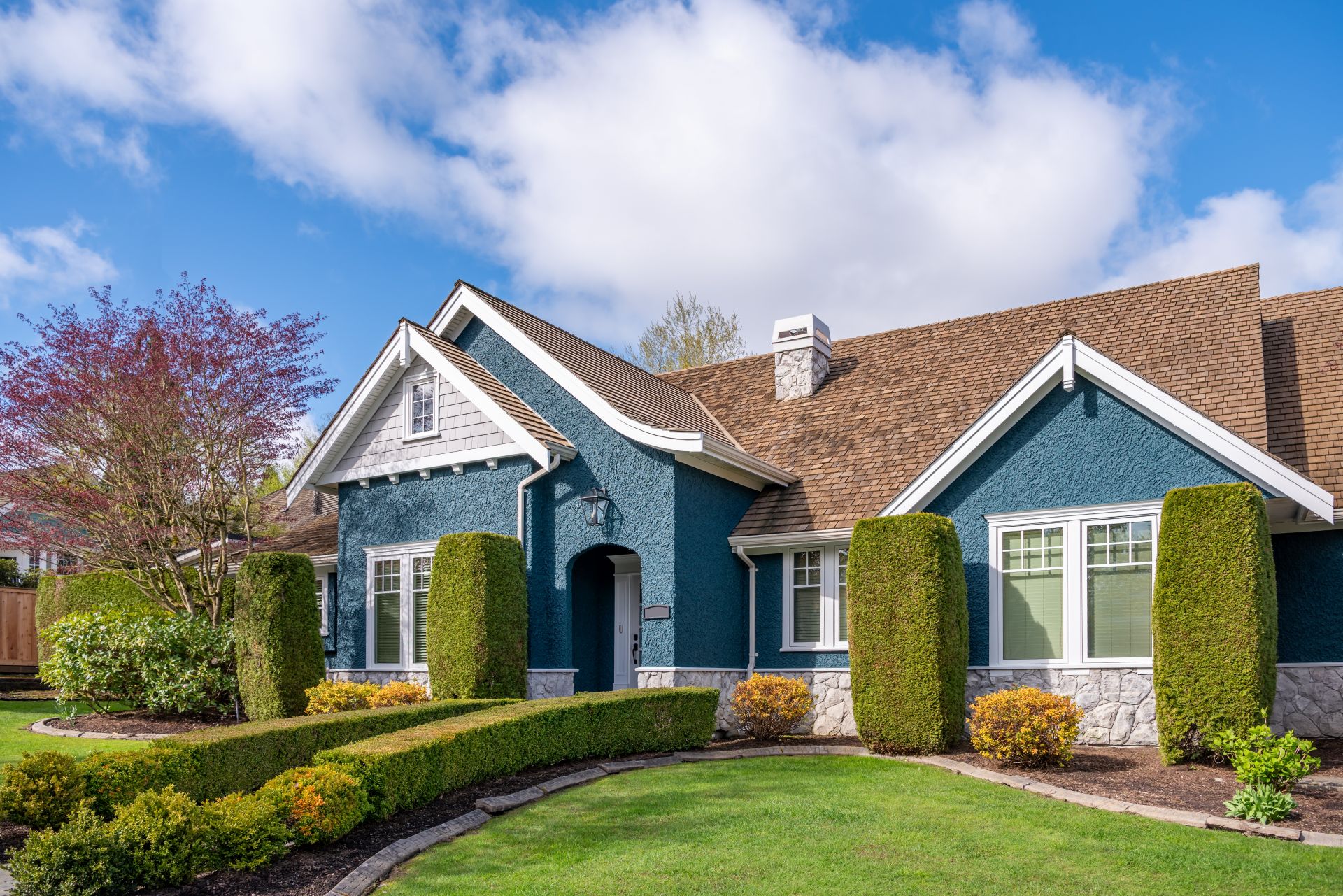 Two story stucco luxury house with nice spring blossom landscape in Vancouver, Canada, North America. Day time on April 2025.