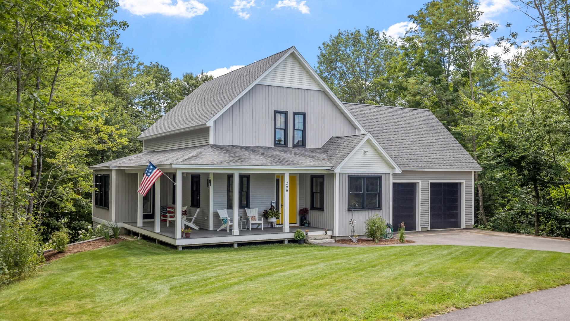 A modern home with an American flag on a sunny day