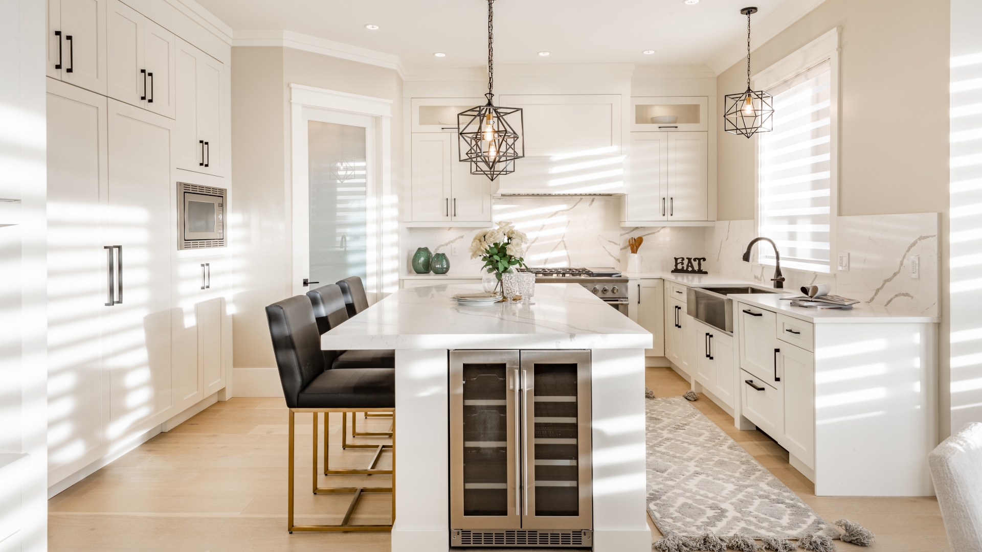 Warm,White,Kitchen,With,Expansive,Countertops,Island,High,End,Appliances