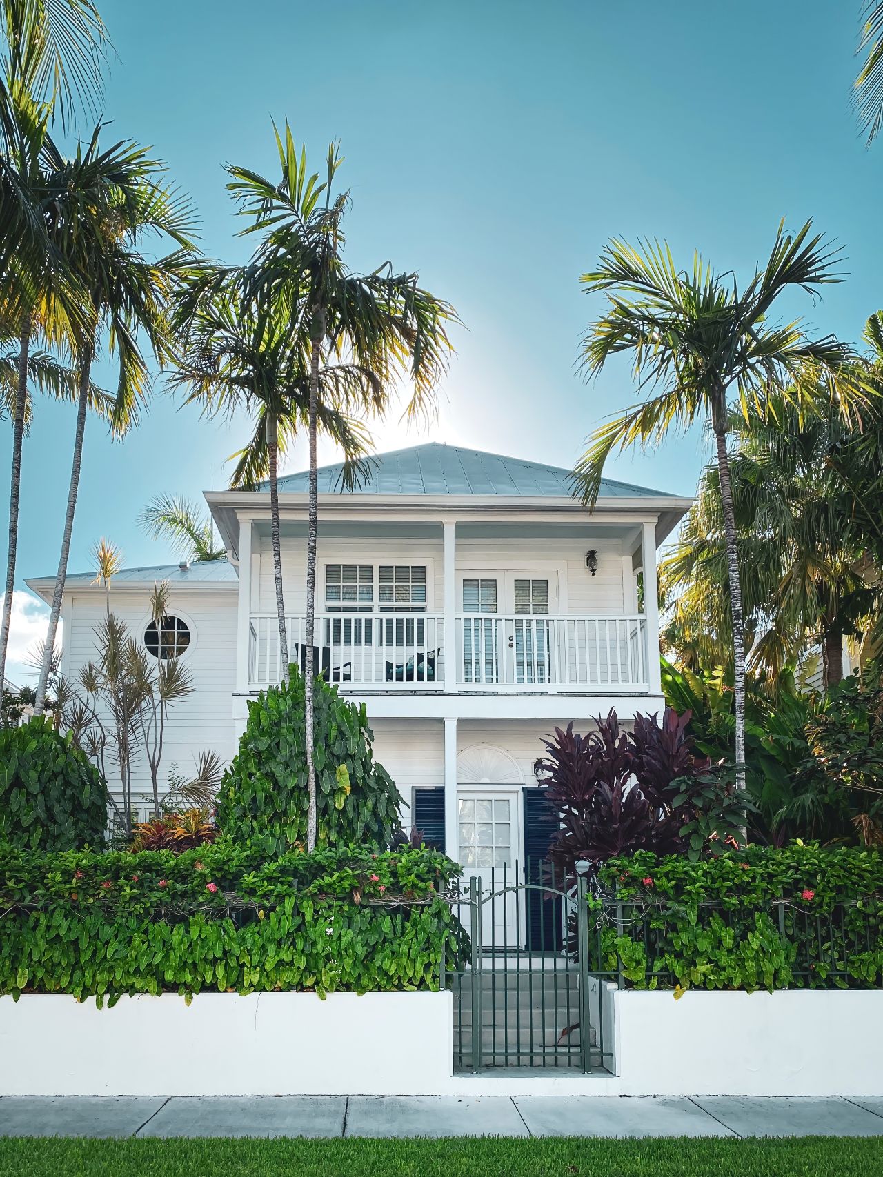 Picturesque house with palm trees in the streets of Key West, Florida, USA against blue sky 1