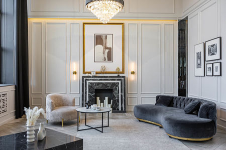 modern living room in a historical style with a marble fireplace in a chic expensive bright interior of a huge apartment without people daytime