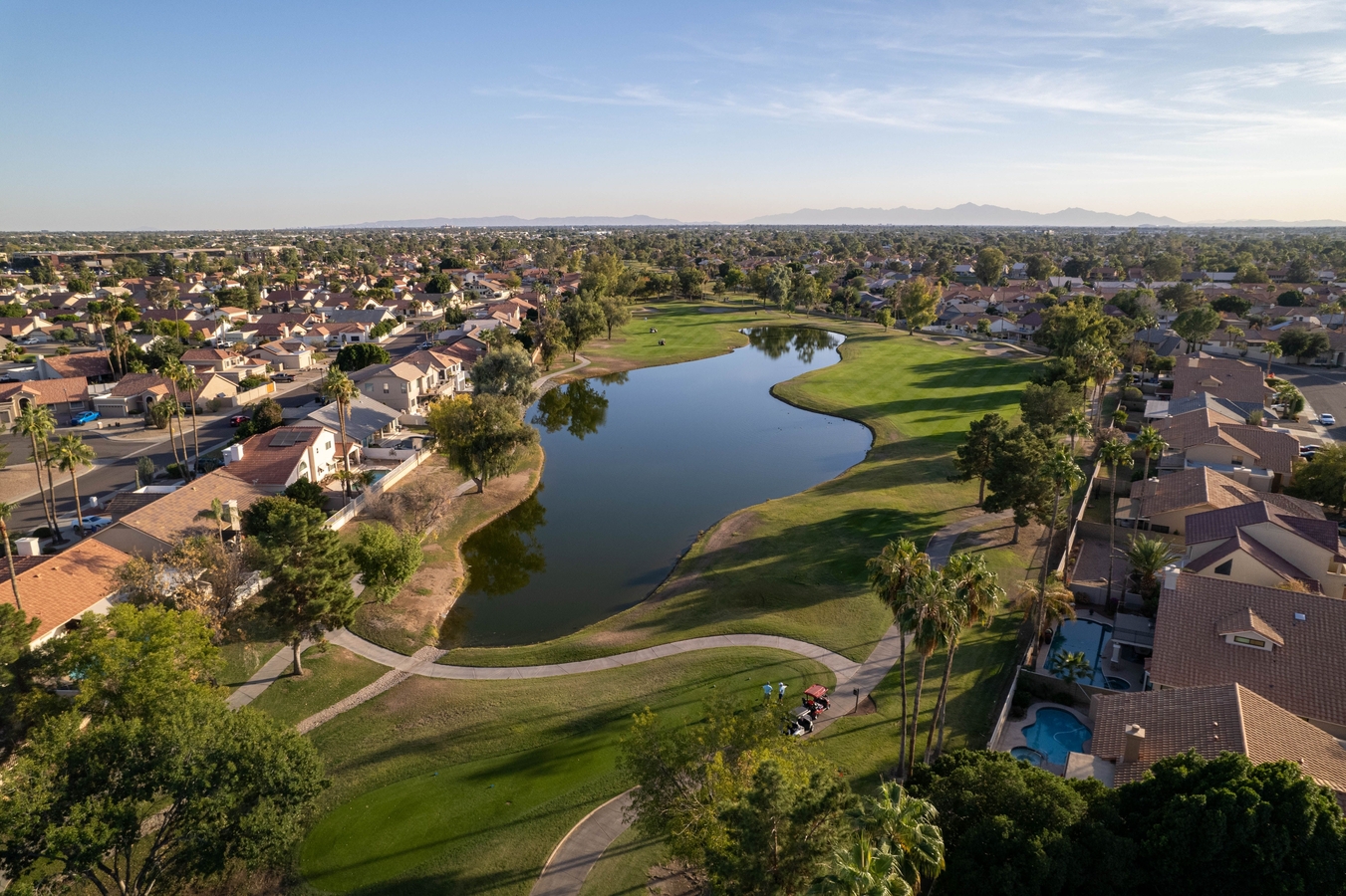 A,Scenic,Residential,Area,With,Green,Trees,And,A,Lake.