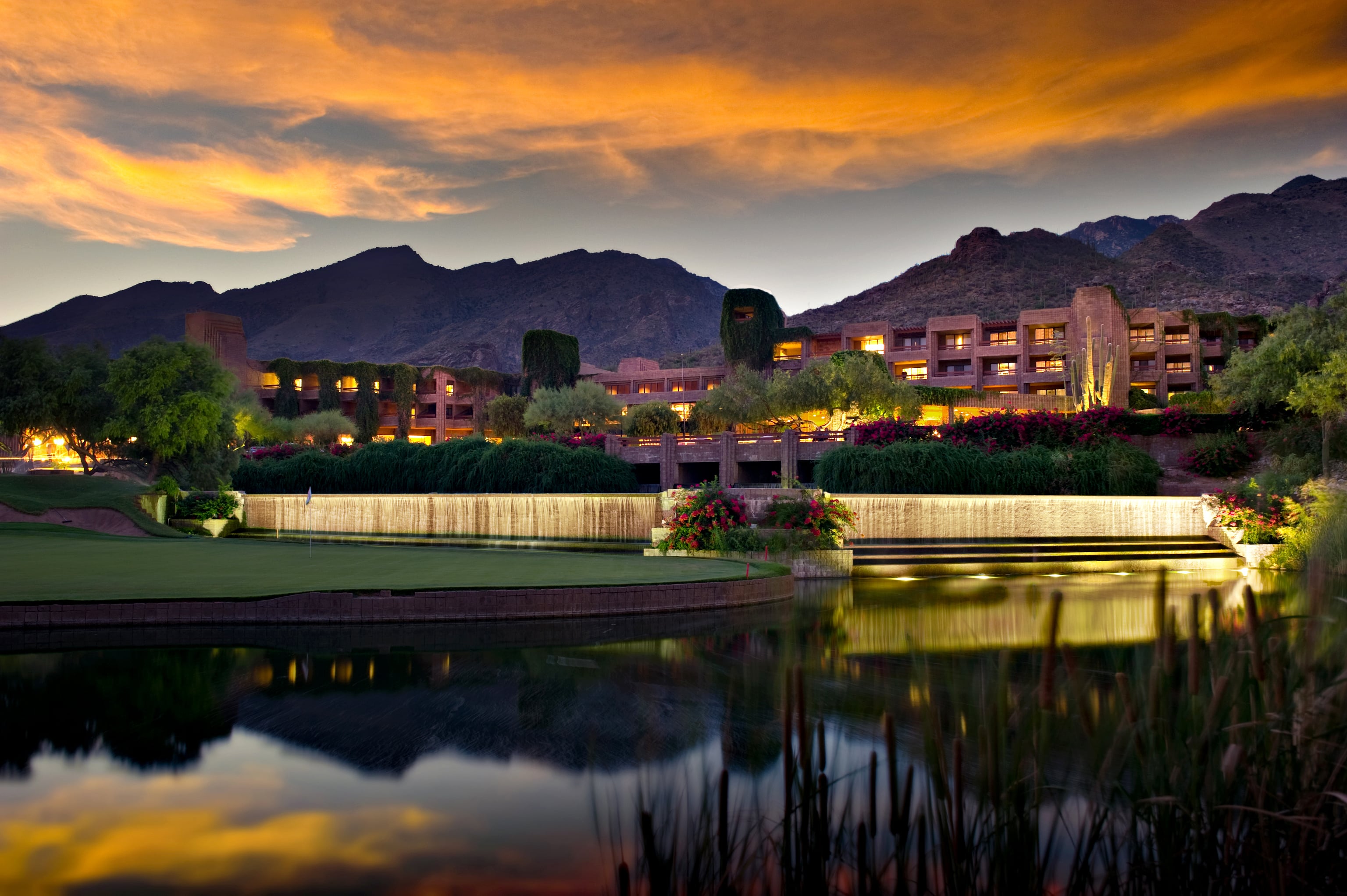 Long exposure of a luxury hotel resort. A golf course and pond is in the foreground and foothill mountains in the background. (1)-min