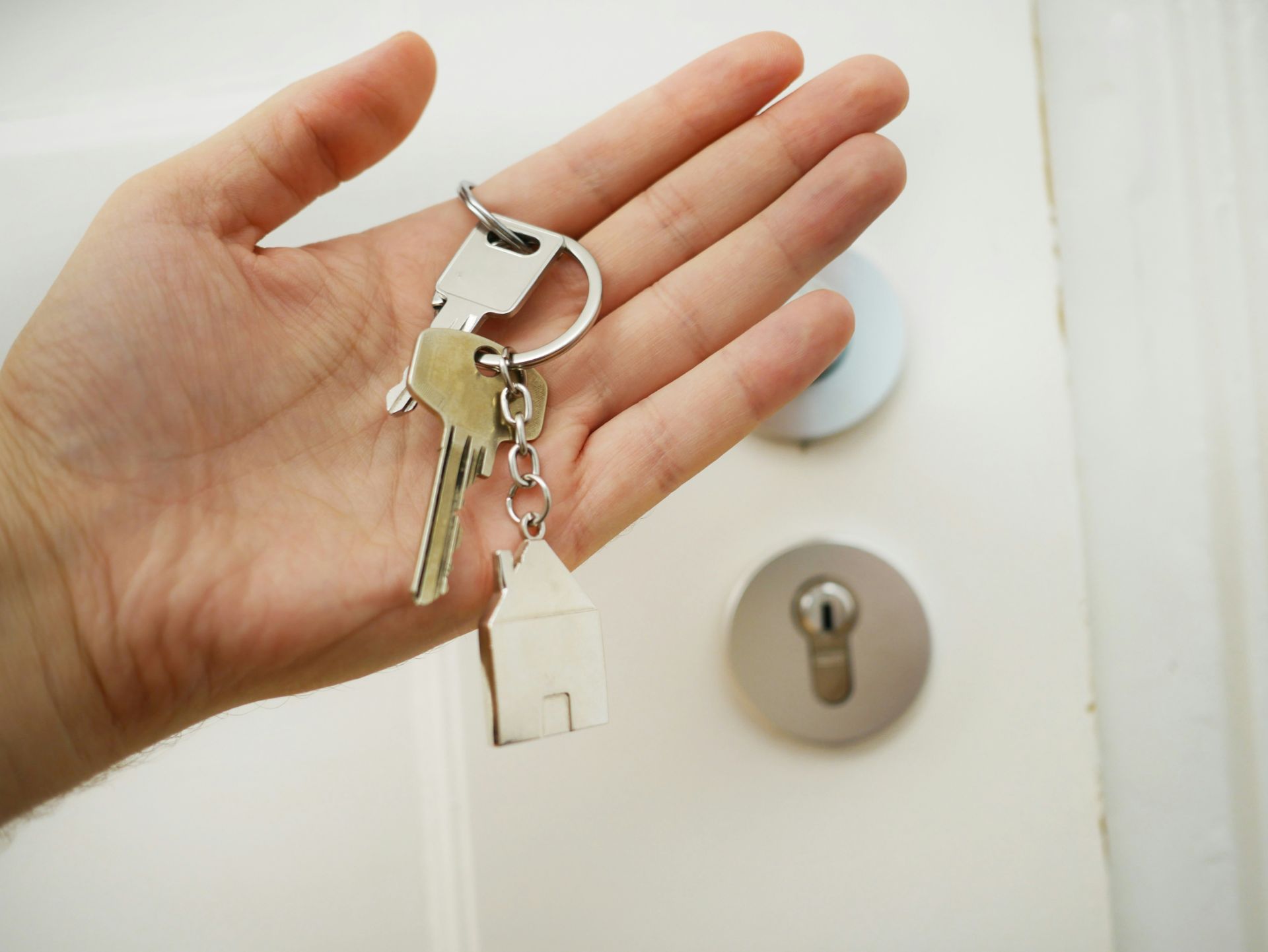 keys in hand with door knob