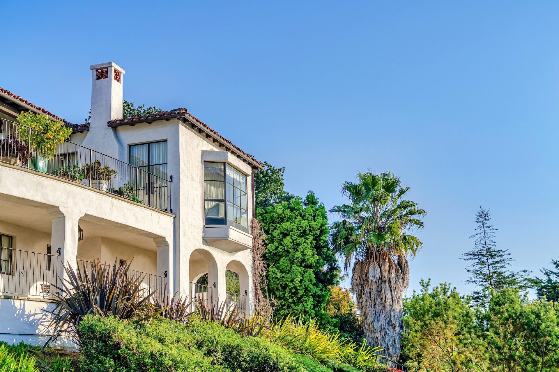 Bay window balcony and porch of house amidst plants in California